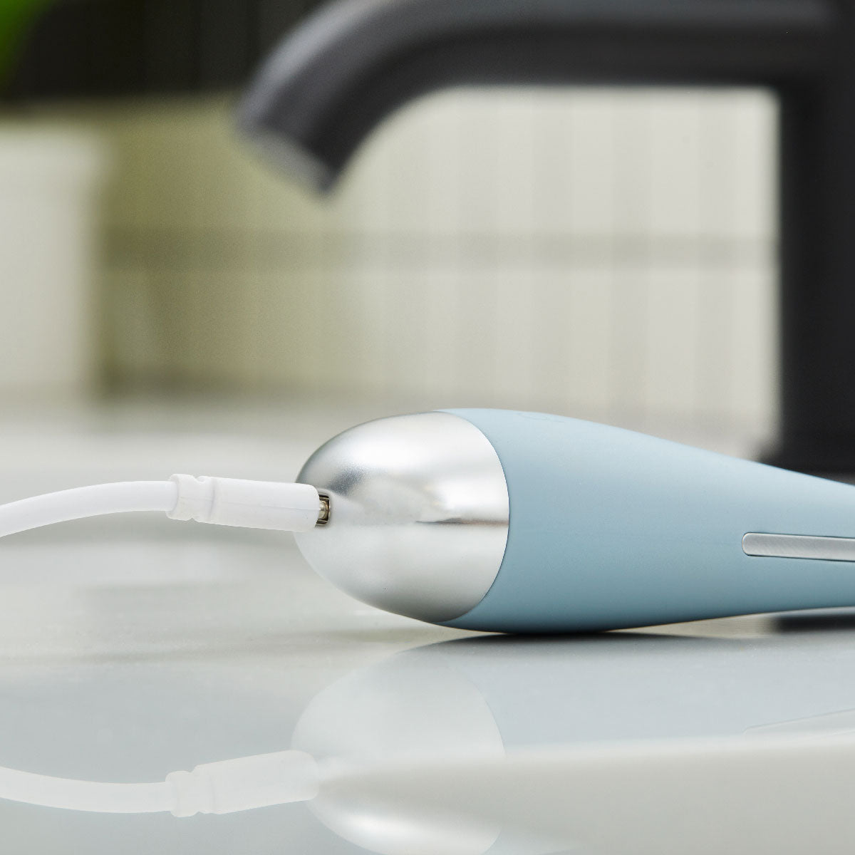 charging cord inserted into bottom of PMD Wave Pro