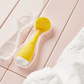 4000-CASE?PMD Clean Mini storage case with yellow PMD Clean Mini inside laying on pink tile with white towel on the side